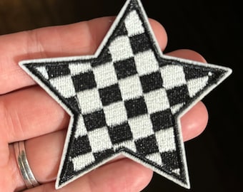 May include: A black and white chequered star-shaped iron-on patch.