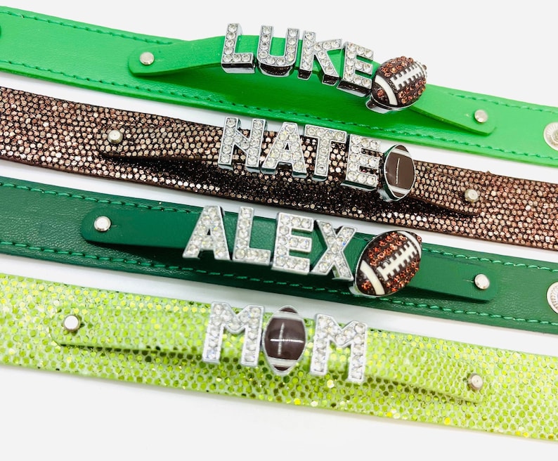 May include: Four green and brown leather bracelets with rhinestones spelling out the names "LUKE", "NATE", "ALEX", and "MOM" with a football charm on each.