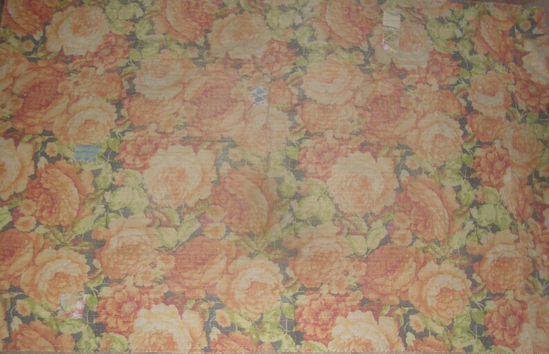 May include: A floral pattern featuring large, orange and peach-colored roses with green leaves against a dark background. The design is repeated across the fabric, creating a dense, textured look. The overall theme is a vintage floral pattern.