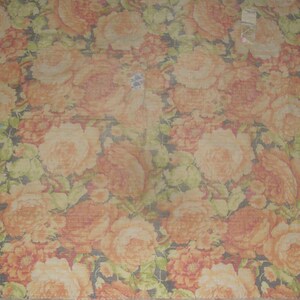 May include: A floral pattern featuring large, orange and peach-colored roses with green leaves against a dark background. The design is repeated across the fabric, creating a dense, textured look. The overall theme is a vintage floral.