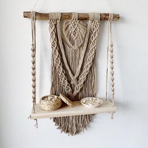 Macrame wall hanging decoration with BOHO shelf in natural terracotta colored cotton. Shelf to hang on the wall. Wallhanging