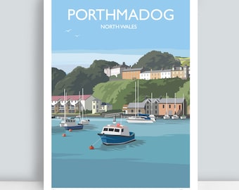 May include: A print of Porthmadog, North Wales, featuring a harbor scene with boats and buildings. The artwork has a blue and green color palette, with the text "Porthmadog" at the top.