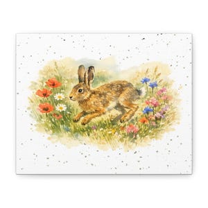 May include: Watercolor painting of a brown hare running through a field of wildflowers. The artwork features red poppies, white daisies, and blue cornflowers. The canvas print has a white background with speckled accents.