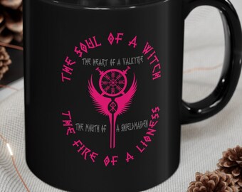 May include: Black coffee mug with a pink graphic design that reads "The Soul of a Witch, The Heart of a Valkyrie, The Fire of a Lioness, The Might of a Shieldmaiden".
