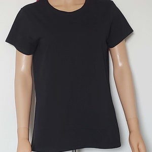 May include: A black short-sleeved t-shirt with a crew neck.