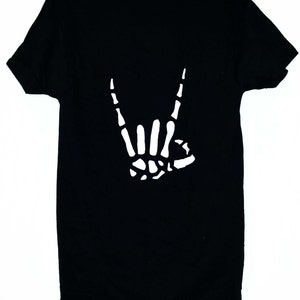 Może przedstawiać: Czarny T-shirt z białym szkieletowym ręką wykonującą gest rock and roll.