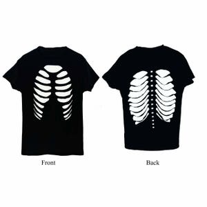 May include: Black t-shirt with a white skeleton rib cage design on the front and back. The front of the shirt is labeled "Front" and the back is labeled "Back". The design is a Halloween-themed graphic.