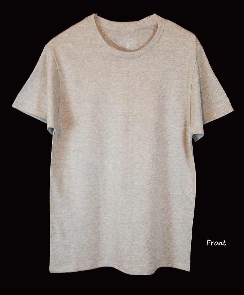 May include: A heather gray short-sleeved t-shirt with a crew neck. The shirt is made of a soft, textured fabric and is displayed against a black background. The word "Front" is written in white script on the lower right side of the shirt.