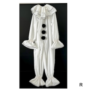 May include: A white clown costume with a ruffled collar and cuffs, accented with black trim. The one-piece outfit features three large black pom-poms down the front and flared sleeves and pant legs.