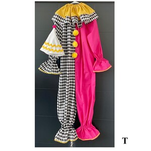 May include: A colorful clown costume with a yellow collar and pom-poms. The costume is split down the middle, with a black and white checkered pattern on one side and bright pink on the other. Includes a matching hat.