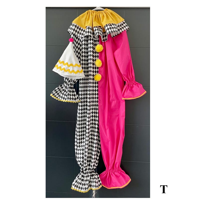 May include: A colorful clown costume with a yellow collar and pom-poms. The costume is split down the middle, with a black and white checkered pattern on one side and bright pink on the other. Includes a matching hat.