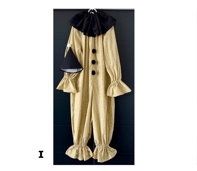 May include: A full-body clown costume in a light tan fabric with a subtle pattern. The costume features a black ruffled collar, three black buttons, and ruffled cuffs and ankles. A matching black cone hat with a white pom-pom is included.