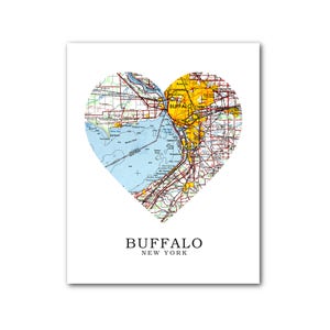 May include: A heart-shaped map of Buffalo, New York, with the city's name and state printed below. The map is in a vintage style with yellow, blue, and red lines representing roads and waterways.