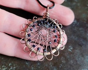 Copper pendant with faceted blue river beads