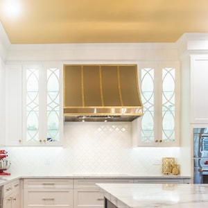Sloped Stainless Steel Hood With Brass Strapping | Custom Range Hoods - Kitchen Stove Decor
