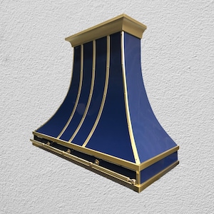 May include: A navy blue range hood with gold trim and accents. The hood has a curved design with vertical gold stripes and a rectangular base. The top and bottom edges are also trimmed in gold.