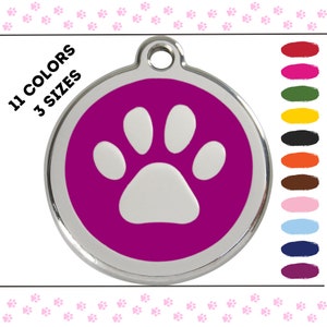 May include: A round, silver dog tag with a white paw print on a magenta background. The tag is available in 11 colors and 3 sizes.