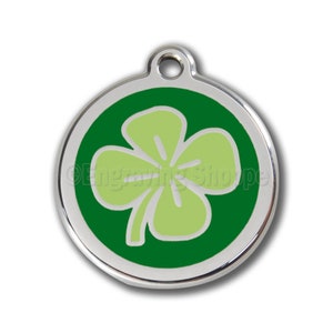 May include: A round silver pet tag with a green shamrock design. The shamrock is light green with a dark green outline.