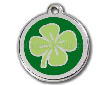 May include: A round silver pet tag with a green shamrock design. The shamrock is light green with a dark green outline.