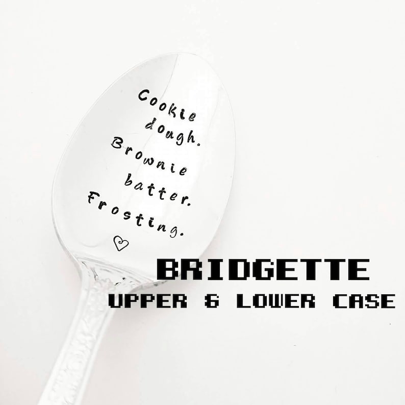 May include: A silver spoon with the words "Cookie dough. Brownie batter. Frosting." and a heart symbol. The name "BRIDGETTE" and "UPPER & LOWER CASE" are printed below the spoon.
