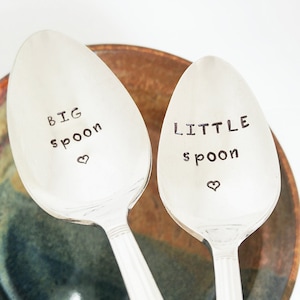 May include: Two silver spoons with the words "BIG SPOON" and "LITTLE SPOON" engraved on them. Each spoon has a small heart engraved below the text.