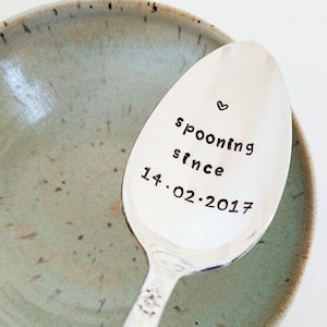 May include: Silver spoon with the text "spooning since 14.02.2017" engraved on it.