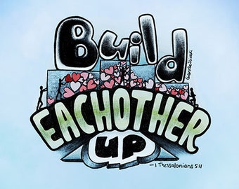 May include: A framed print with a blue background and a colorful illustration of the words "Build Each Other Up" with hearts and people. The text "1 Thessalonians 5:11" is included below the illustration.