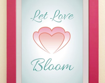May include: A framed print with a pink and white heart design and the text "Let Love Bloom" in teal blue lettering.