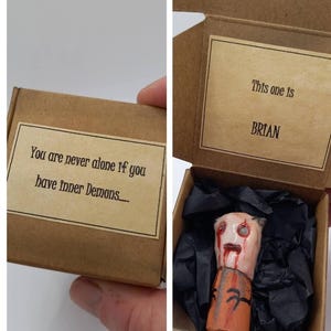 May include: A small brown cardboard box containing a miniature figurine named Brian. The box lid features the text 'You are never alone if you have inner Demons....' and the inside lid reads 'This one is BRIAN'. The figurine has a pale head with red markings and a brown body.