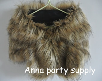 Peut inclure: Un châle en fausse fourrure marron avec une doublure noire. Le châle est suspendu à un cintre. Le texte "Anna party supply" est visible en bas de l'image.