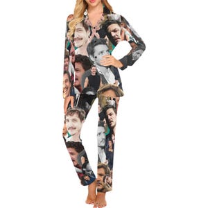 May include: A two-piece pajama set featuring a collage of faces in various poses. The long-sleeved top has a button-down front and a V-neck. The pajama pants have a matching design. The pajamas are made of a soft, comfortable material.