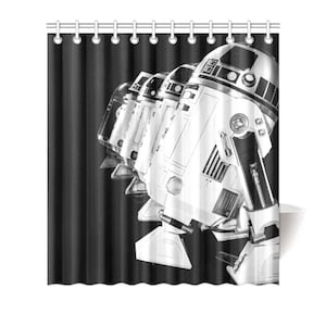 May include: Black and white shower curtain featuring a line of R2-D2 robots from Star Wars.