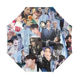 Puede incluir: Un paraguas octogonal con un collage de imágenes de un grupo musical. Las imágenes son de varios miembros en diferentes poses y atuendos. La combinación de colores incluye azules, blancos y varios tonos de piel.