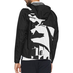 May include: Black hooded jacket with a white abstract design on the back. The jacket has a full-length zipper and a white lining. The jacket is made of a lightweight material and has a drawstring hood.