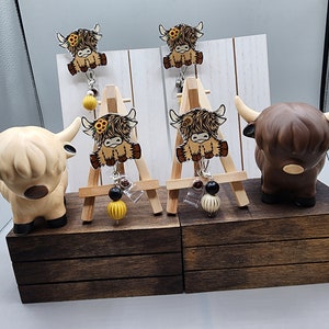 Highland cow with sunflowers badge reel
