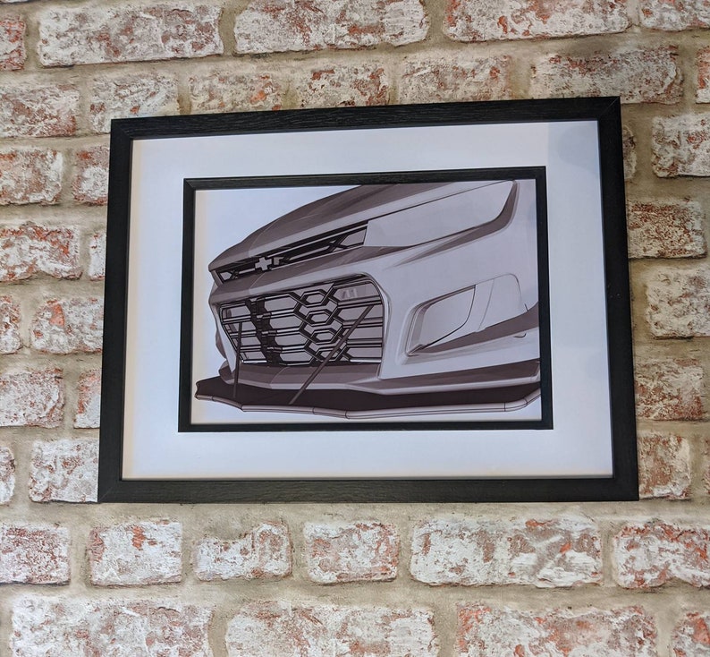 May include: A black and white illustration of the front end of a car. The car has a black grille with a honeycomb pattern and a silver bumper.