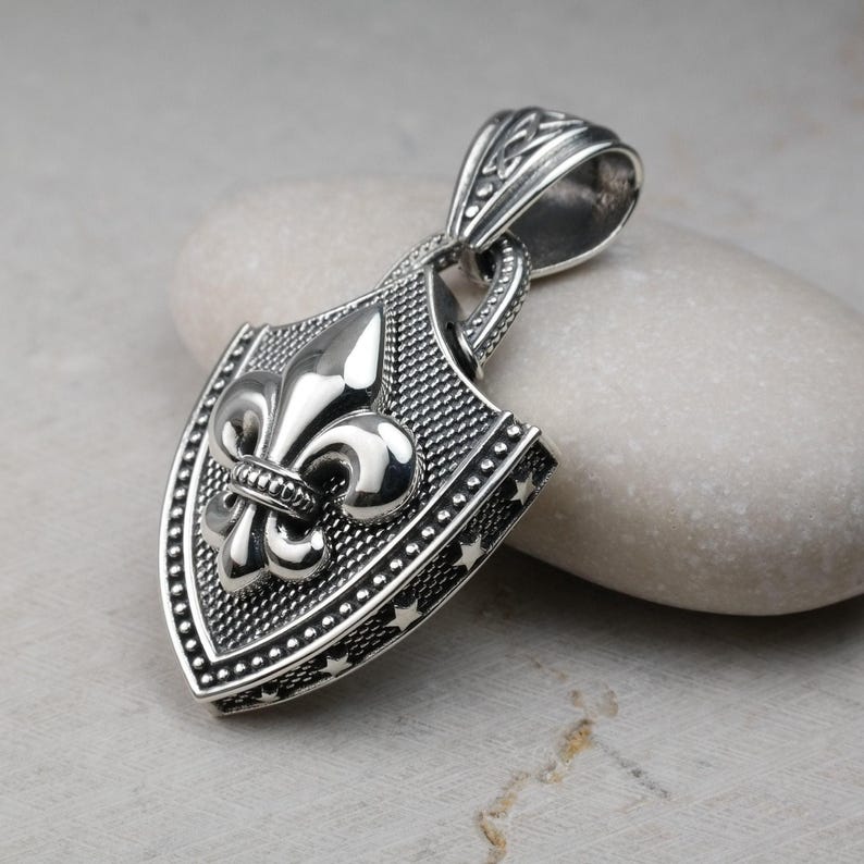 Fleur De Lis Knot Necklace with Spiga Neck Chain, Shield Shape Pendant with Classic Hook Attached to the Frame, the Final Look of the Pendant is Polished Frame and the fleur de lis is Silver Polished (photo 1)