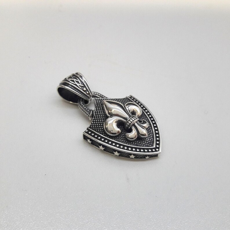 Fleur De Lis Knot Necklace with Spiga Neck Chain, Shield Shape Pendant with Classic Hook Attached to the Frame, the Final Look of the Pendant is Matte Frame and the fleur de lis is Silver Polished (photo 3)