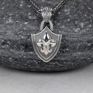 Fleur De Lis Knot Necklace with Spiga Neck Chain, Shield Shape Pendant with Classic Hook Attached to the Frame, the Final Look of the Pendant is Polished Frame and the fleur de lis is Silver Polished (photo 2)