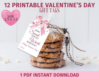 May include: Printable Valentine's Day gift tags with pink hearts and the text "How Sweet It Is To Work With You!"  Happy Valentine's Day! From..." The tags are 2.5 inches by 3.5 inches.