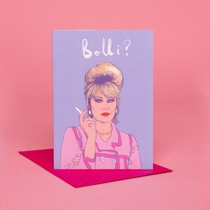 Peut inclure: Une carte de v&oelig;ux illustrant une femme de dessin anim&eacute; avec une coiffure bouffante, portant une veste rose et tenant une cigarette. Le texte "Bollo?" est &eacute;crit en blanc sur un fond violet clair.