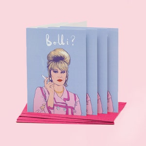 Peut inclure: Un ensemble de quatre cartes de v&oelig;ux illustrant une femme de dessin anim&eacute; aux cheveux blonds, portant une veste rose et tenant une cigarette. Le texte sur la carte est "Bollo?"