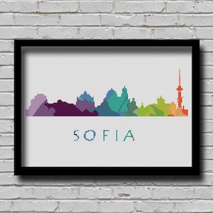 May include: A colorful pixelated skyline of Sofia, Bulgaria, with the city name written below. The skyline is made up of different colored blocks, representing buildings and landmarks.