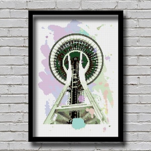 Może przedstawiać: Pikselowa ilustracja Space Needle w Seattle, w stanie Waszyngton. Space Needle jest przedstawiona w biało-szaro-zielonej kolorystyce. Tło stanowi białe płótno z kolorowymi plamami akwarelowymi w odcieniach różowego, fioletowego, niebieskiego i zielonego.