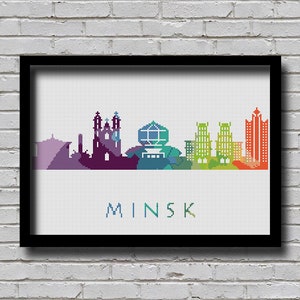 May include: A colourful pixelated cityscape of Minsk, Belarus. The skyline features various buildings in shades of purple, blue, green, yellow, and orange. The word "MINSK" is written in white below the cityscape.