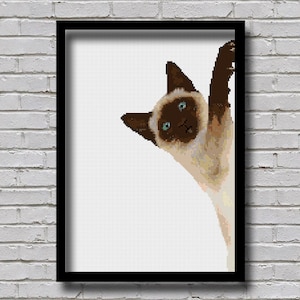 May include: A framed print of a Siamese cat peeking around the corner with a curious expression. The cat has blue eyes and brown markings on its face and ears. The background is white.