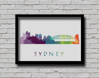 May include: A colorful cross-stitch design of the Sydney skyline, featuring the Sydney Harbour Bridge and the Opera House. The text "SYDNEY" is written below the skyline.