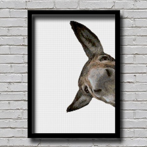 May include: A close-up of a donkey's head peeking around a corner, with a white background. The donkey has brown and gray fur, and its ears are pointed forward.