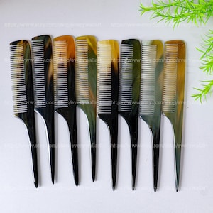 May include: A set of eight horn combs with black and brown mottled patterns. The combs have a pointed end and a wide, flat handle.
