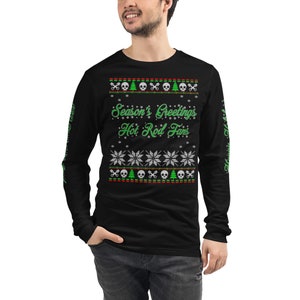 May include: Black long-sleeve shirt with a green and white Christmas-themed design. The shirt features the text "Season's Greetings Hot Rod Fans".